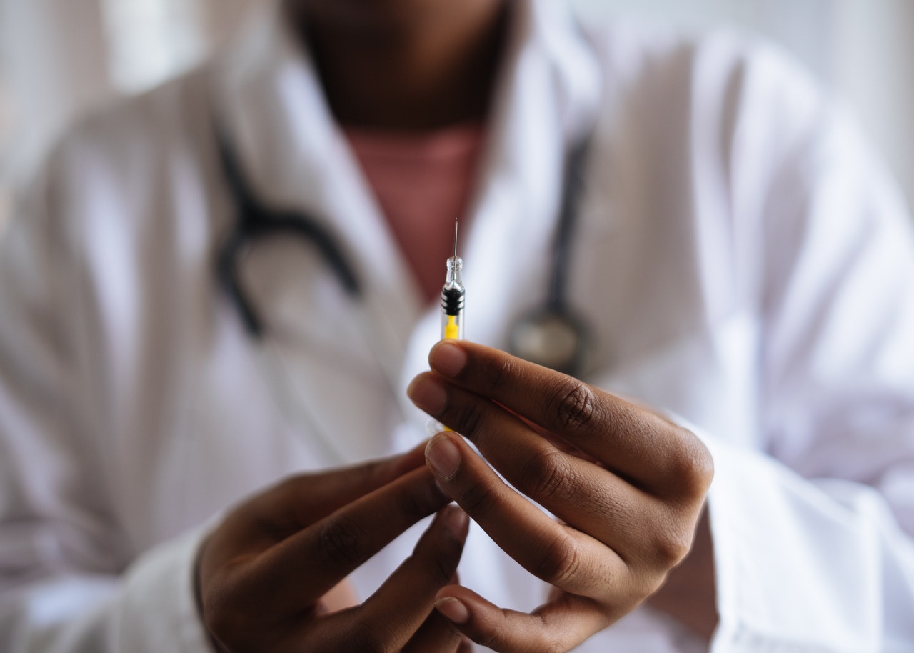 doctor holding an injection