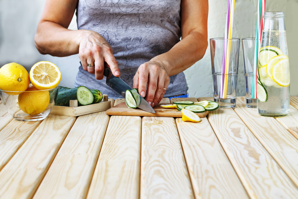 person cutting fruits