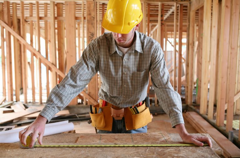 man measuring the wood