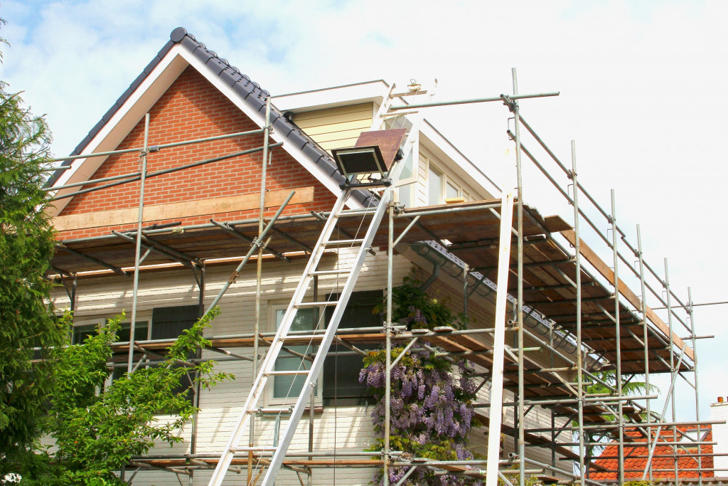 renovation of a house with scaffoldings around it