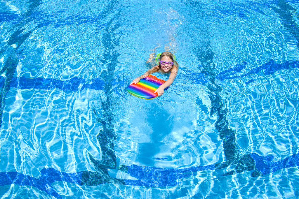 child swimming on a pool during summer