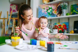 mother and baby painting together