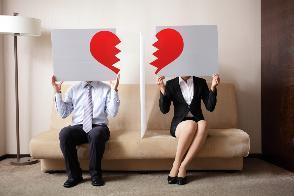 two people holding a broken heart sign