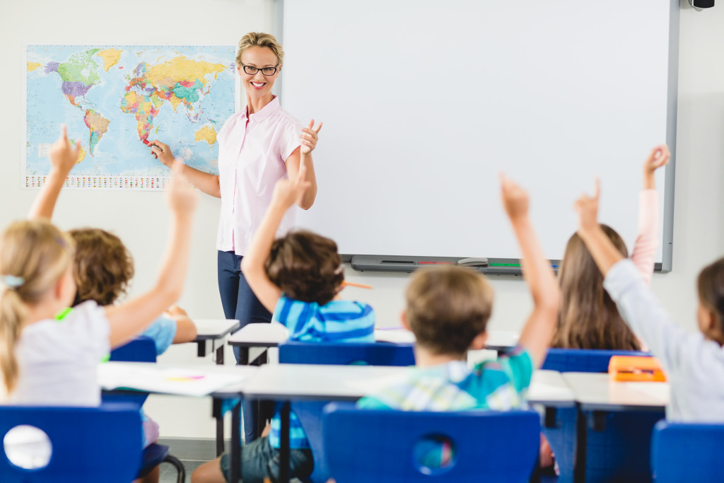 Teacher and young students in a classroom