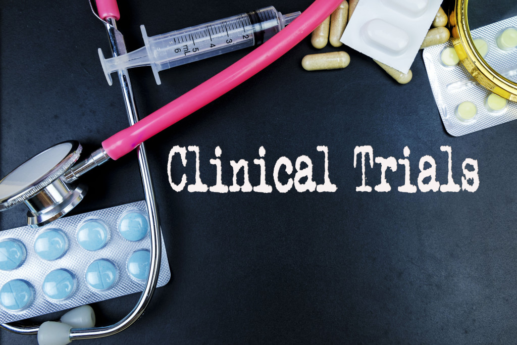 Scattered medical supplies and needs with the word clinical trials