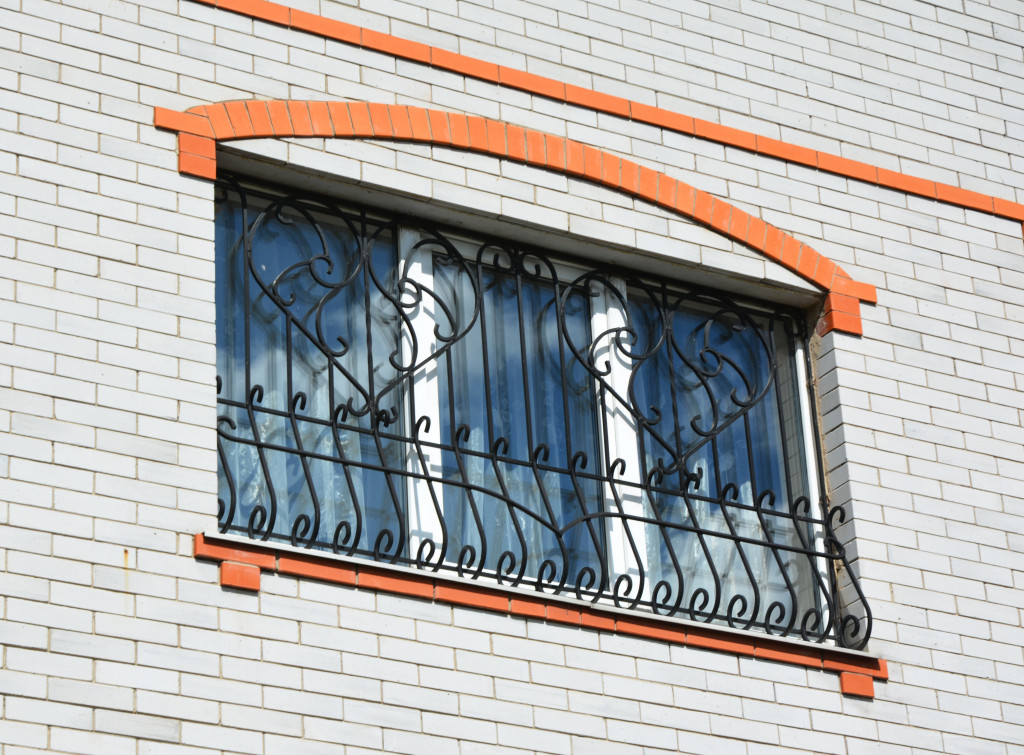 Metal grills installed on the window of a house.