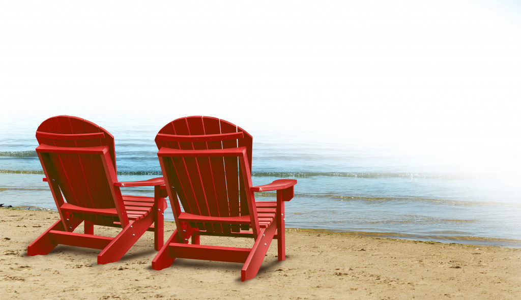 Two empty chairs facing the ocean symbolizing retirement