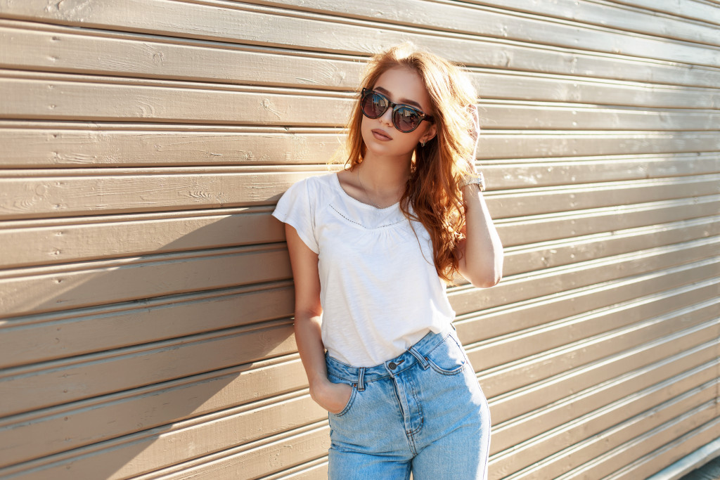 A stylish woman wearing a cotton shirt and a high waist denim jeans