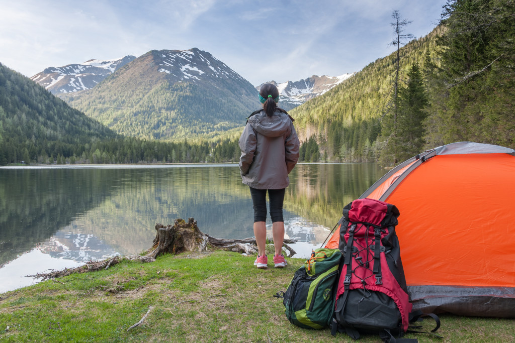 a solo backpacker enjoying a view while camping 