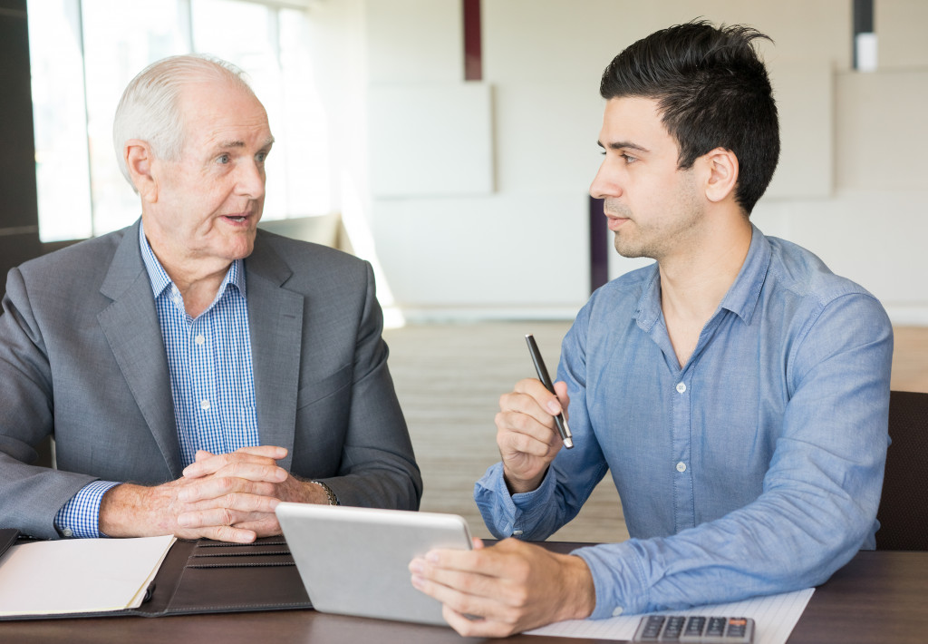 A senior man providing mentorship to a young man