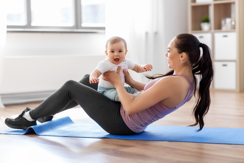 stay at home mom exercising with her baby