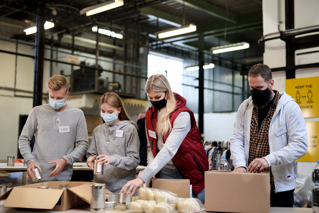 community members helping pack boxes of relief goods