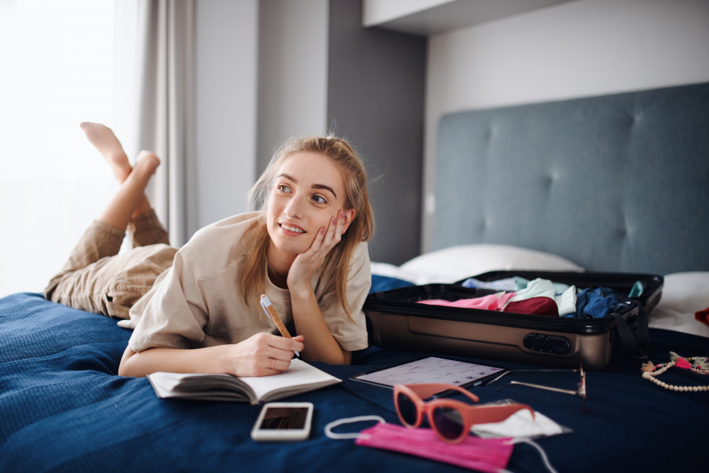 A woman packing her clothes and essentials for a trip