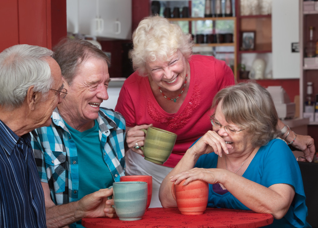 group of laughing seniors in a coffeeshop