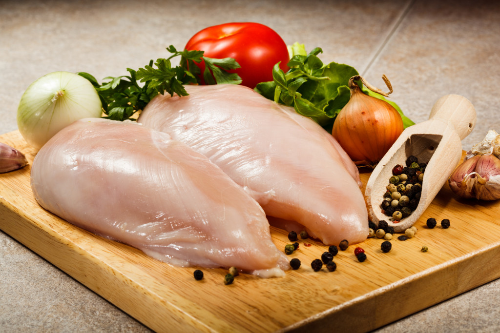 Cuts of chicken breasts on a chopping board