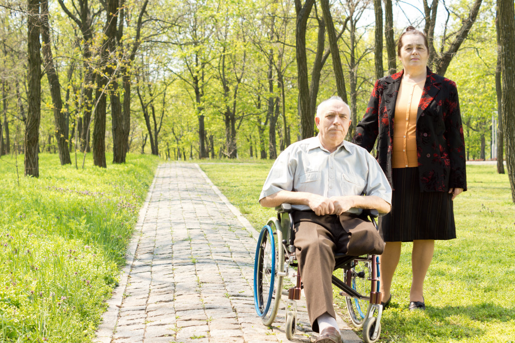 man with one leg on a wheelchair and his wife