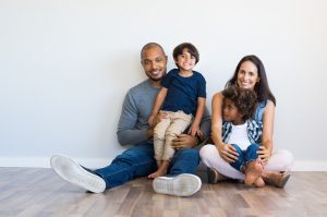 happy multiethnic family sitting on the floor at home