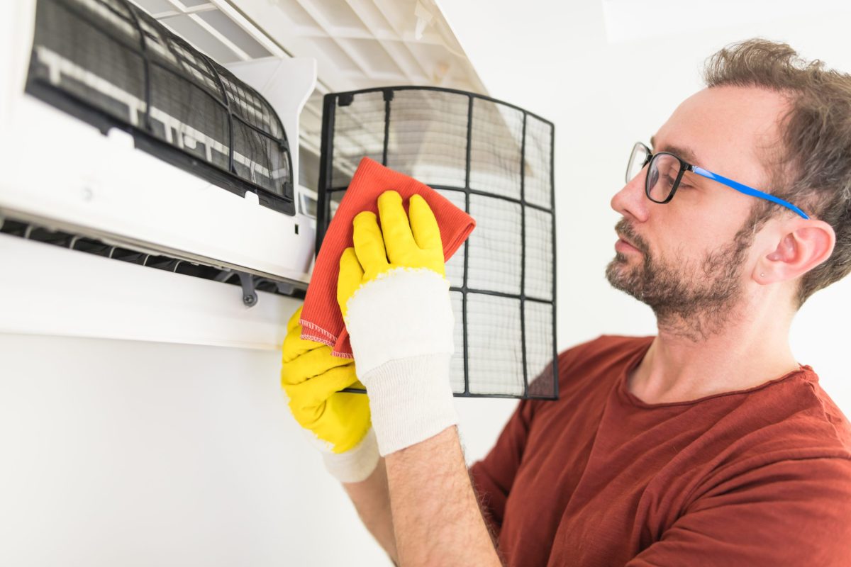 Cleaning the air filter of an air conditioner at home.