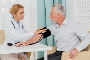 Doctor placing blood pressure cuff