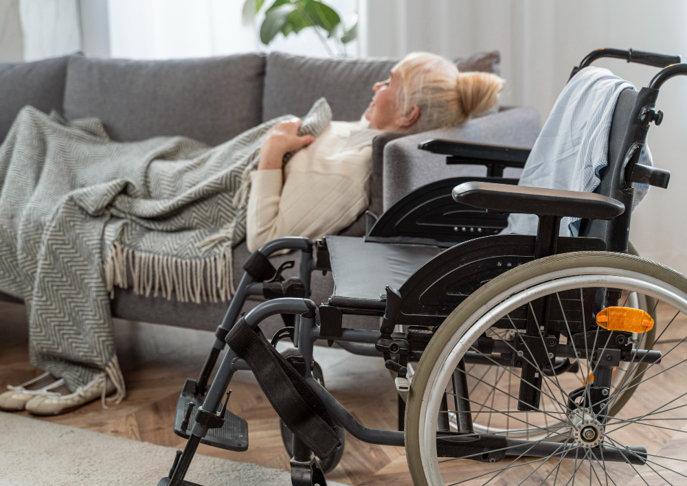 Senior woman lying in bed next to a wheelchair